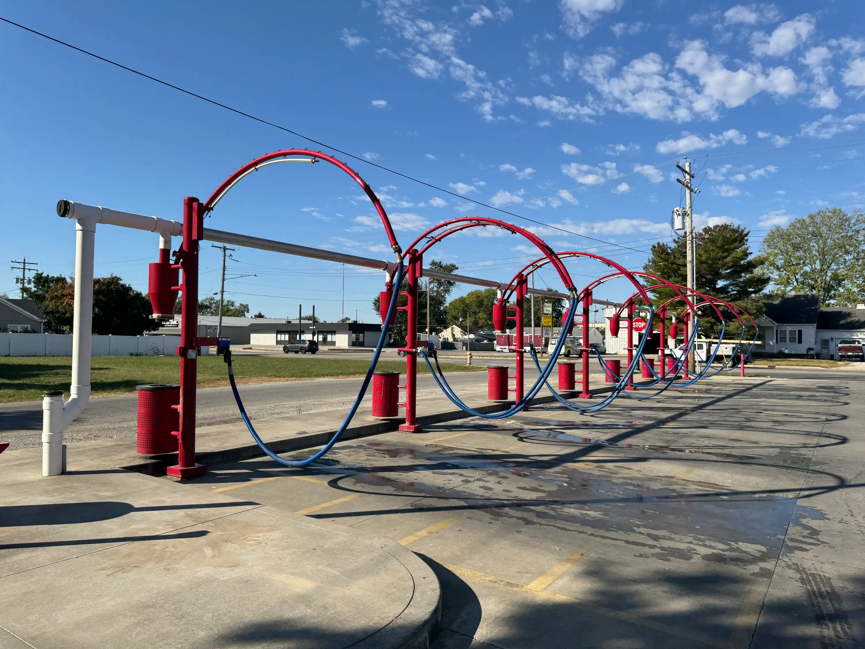 The row of red vacuum arches at Southtown Car Wash under a clear sky
