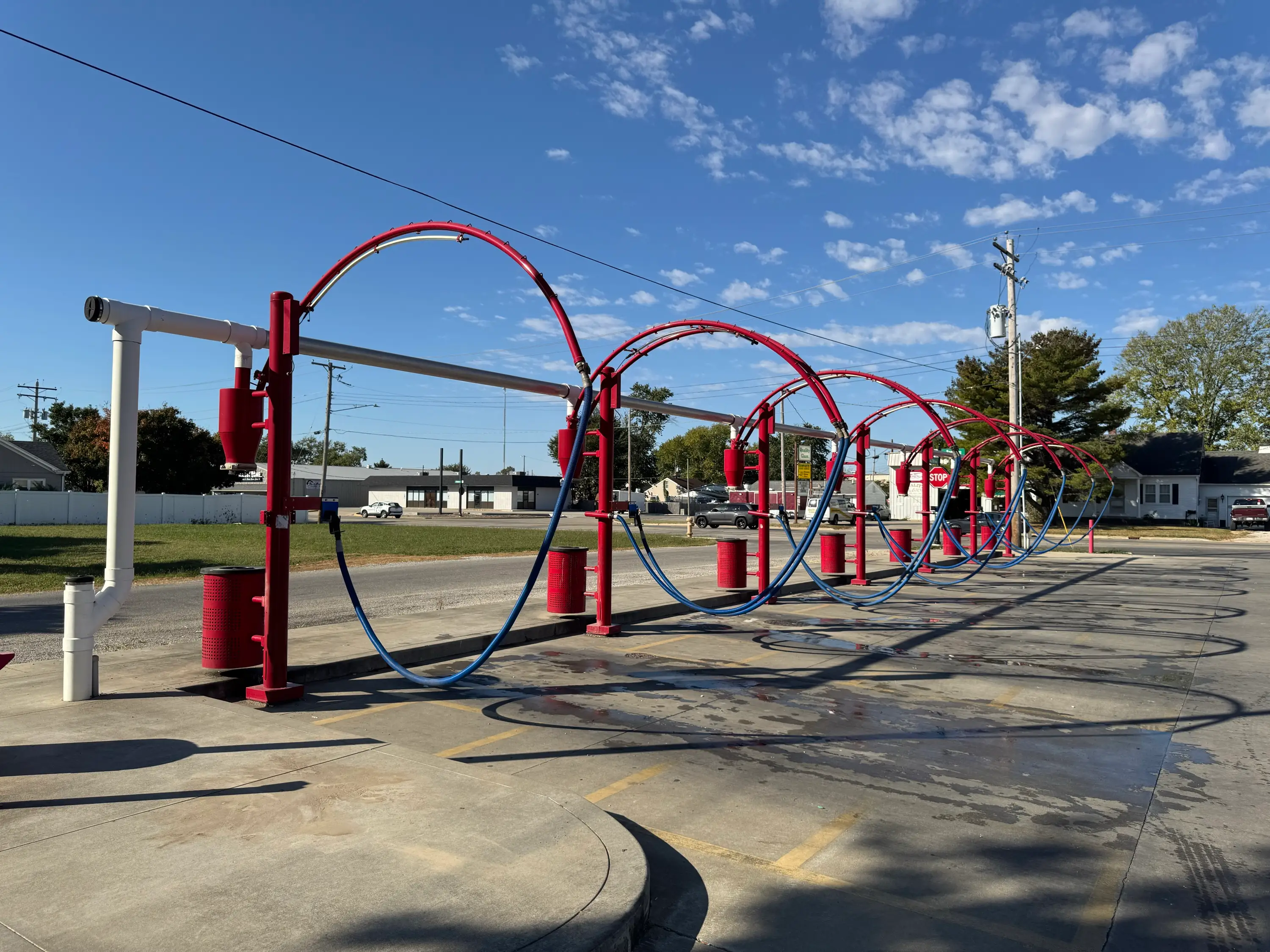 The row of red vacuum arches at Southtown Car Wash on a clear morning