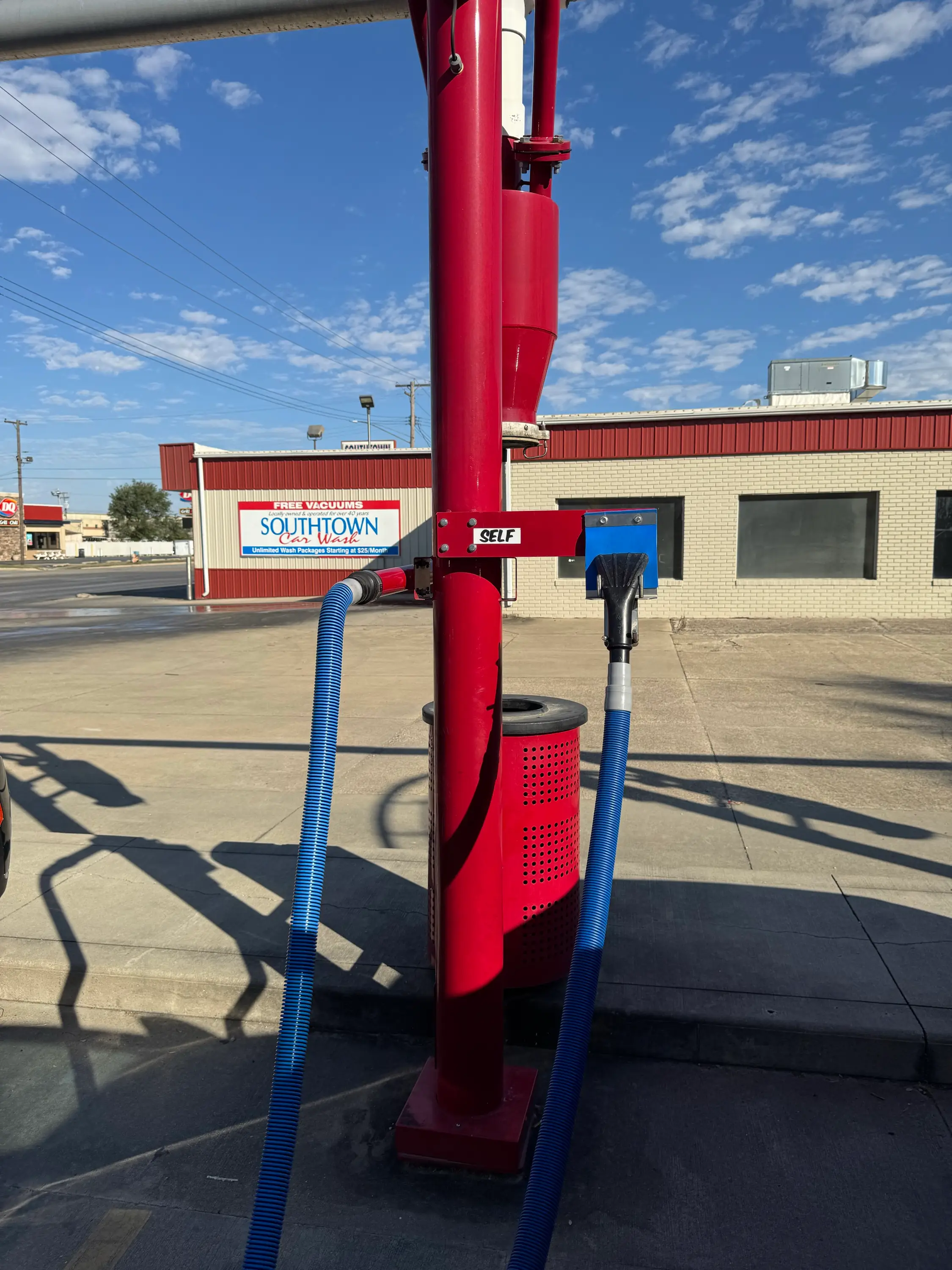 A free vacuum station at Southtown Car Wash, with the Free Vacuums sign behind it